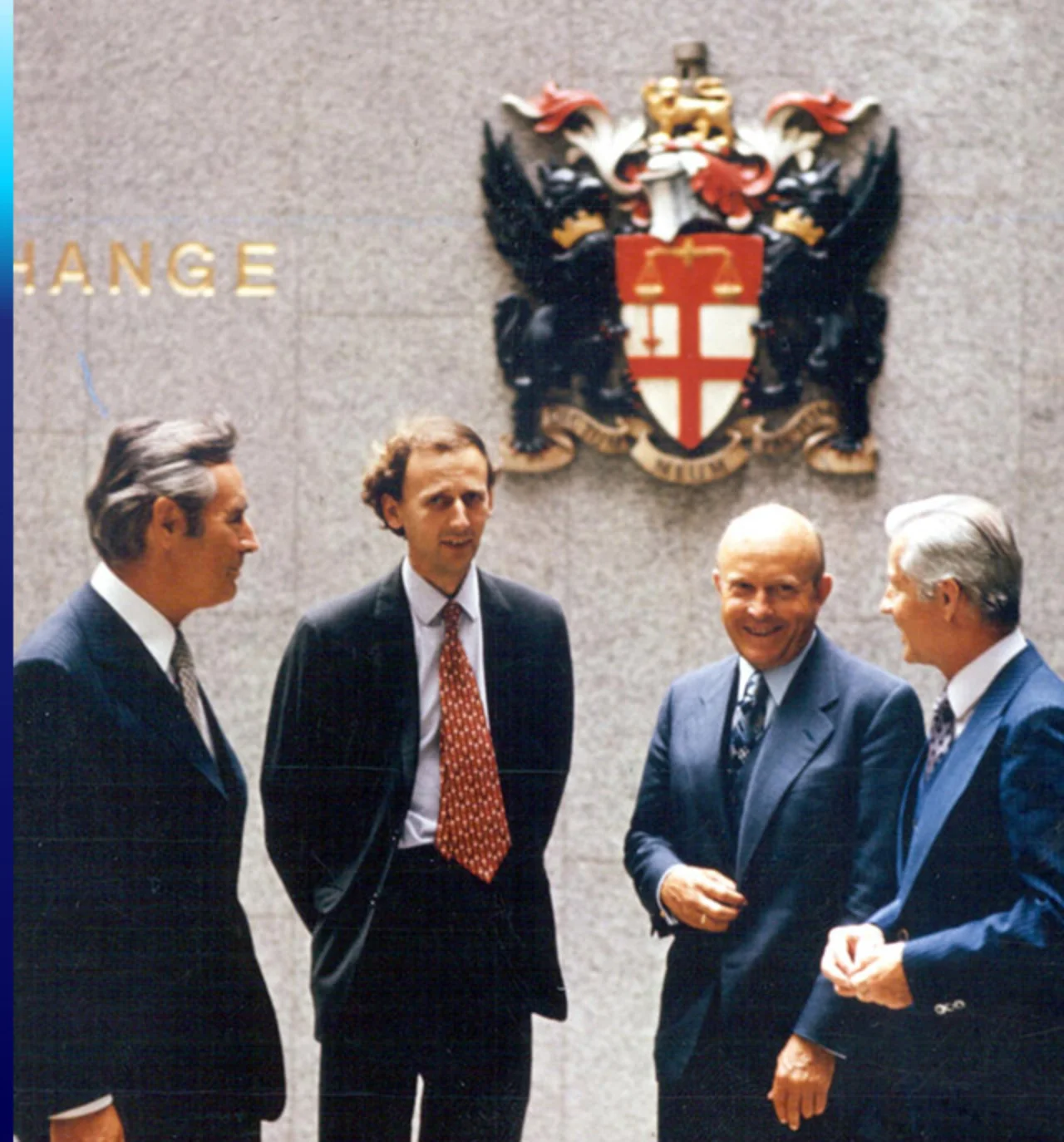 Four Deutsche Bank employees stand in from of the London Stock Exchange as shares are listed for the first time in 1976